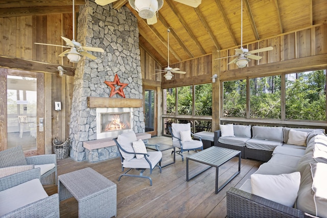 living area with high vaulted ceiling, a ceiling fan, wooden walls, wood-type flooring, and wood ceiling