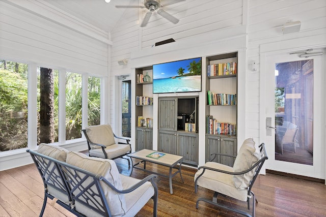 sunroom with an outdoor hangout area, a ceiling fan, high vaulted ceiling, and hardwood / wood-style flooring