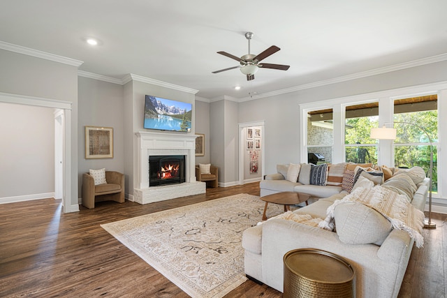 410 Coastal Breeze Dr, Freeport, FL 32439 - living area with a lit fireplace, ornamental molding, a ceiling fan, recessed lighting, and dark wood-type flooring