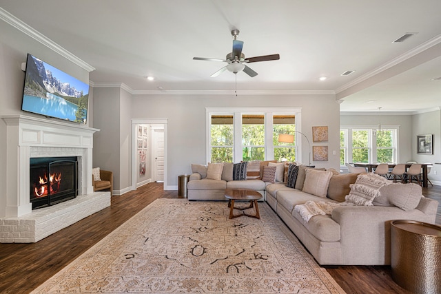 410 Coastal Breeze Dr, Freeport, FL 32439 - living room with dark wood finished floors, recessed lighting, ceiling fan, ornamental molding, and a fireplace