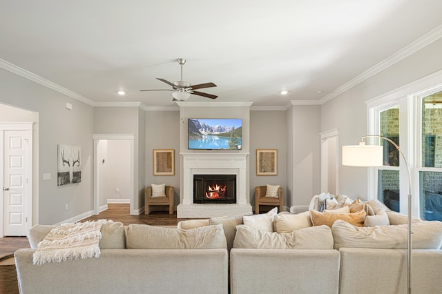 410 Coastal Breeze Dr, Freeport, FL 32439 - living area featuring a glass covered fireplace, recessed lighting, a ceiling fan, ornamental molding, and wood finished floors
