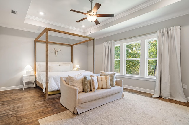 410 Coastal Breeze Dr, Freeport, FL 32439 - bedroom with wood finished floors, baseboards, ornamental molding, a tray ceiling, and recessed lighting