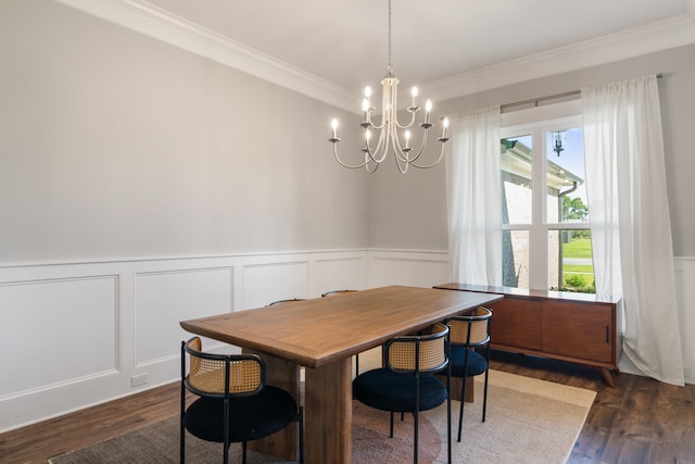 410 Coastal Breeze Dr, Freeport, FL 32439 - dining area with a chandelier, crown molding, wood finished floors, a decorative wall, and a wainscoted wall