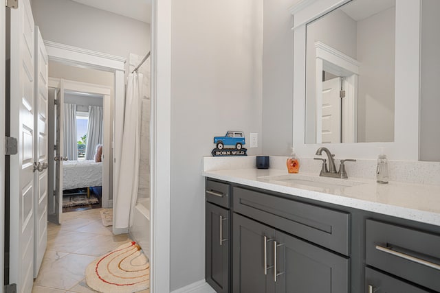 410 Coastal Breeze Dr, Freeport, FL 32439 - ensuite bathroom featuring vanity, marble look tiles, and shower / tub combo