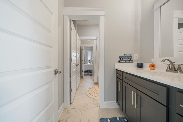 410 Coastal Breeze Dr, Freeport, FL 32439 - ensuite bathroom featuring vanity, marble finish flooring, and baseboards