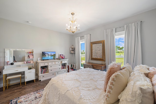 410 Coastal Breeze Dr, Freeport, FL 32439 - bedroom with a chandelier and dark wood-style flooring