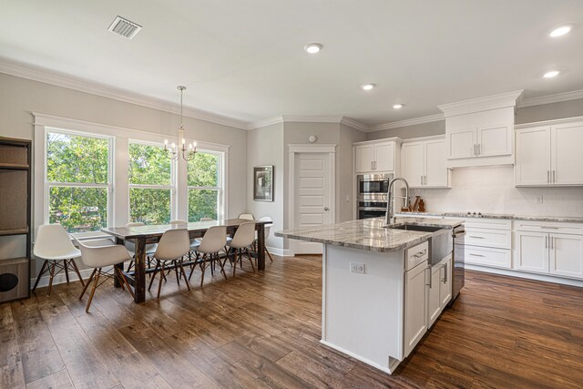 410 Coastal Breeze Dr, Freeport, FL 32439 - kitchen with a sink, stainless steel appliances, a chandelier, white cabinets, and ornamental molding
