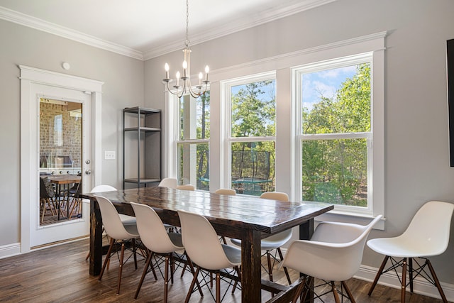 410 Coastal Breeze Dr, Freeport, FL 32439 - dining room featuring dark wood-style flooring, plenty of natural light, a chandelier, baseboards, and crown molding
