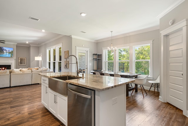 410 Coastal Breeze Dr, Freeport, FL 32439 - kitchen with dishwasher, a sink, a chandelier, a lit fireplace, and dark wood-style floors