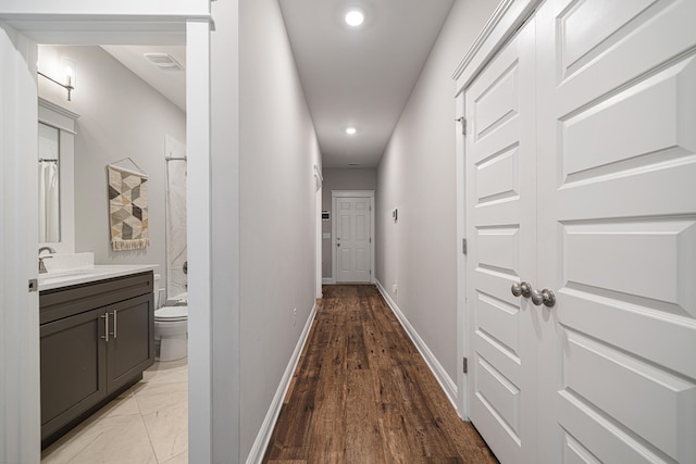 410 Coastal Breeze Dr, Freeport, FL 32439 - hallway featuring baseboards, recessed lighting, a sink, and light wood-type flooring
