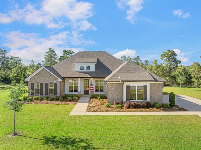 410 Coastal Breeze Dr, Freeport, FL 32439 - view of front of home with brick siding, a front lawn, and a shingled roof