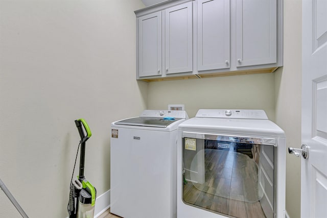 laundry room with washer and clothes dryer and cabinet space