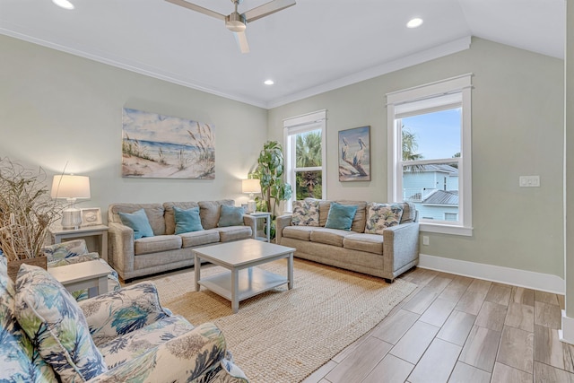 living area with a ceiling fan, recessed lighting, baseboards, ornamental molding, and light wood-style floors
