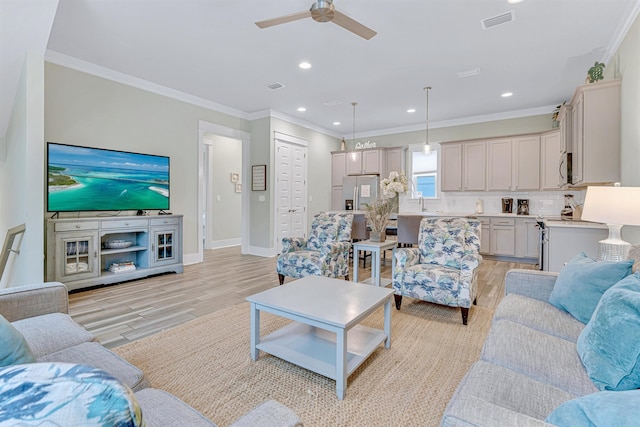 living area with light wood-type flooring, ceiling fan, baseboards, crown molding, and recessed lighting