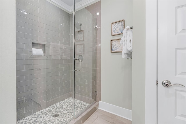 full bath with a stall shower, baseboards, and tile patterned floors