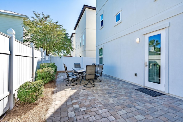 view of patio with a fenced backyard and outdoor dining area