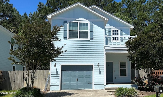 76 Mosaic Oaks Cir, Santa Rosa Beach, FL 32459 - view of front facade with an attached garage, board and batten siding, and a balcony