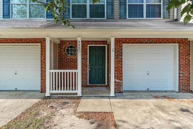 282 Swaying Pine Ct, Crestview, FL 32539 - doorway to property with brick siding, concrete driveway, and a garage