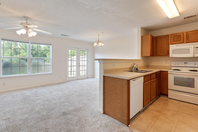 282 Swaying Pine Ct, Crestview, FL 32539 - kitchen with white appliances, a sink, a textured ceiling, a chandelier, and brown cabinetry