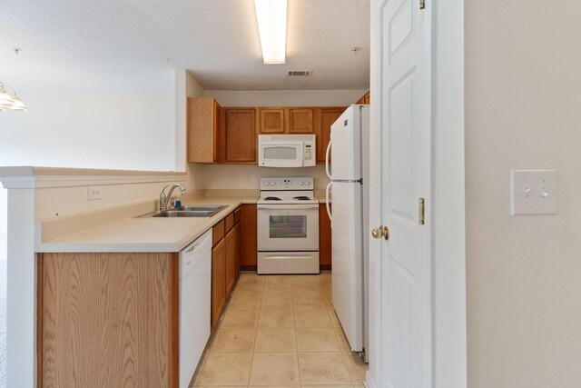 282 Swaying Pine Ct, Crestview, FL 32539 - kitchen featuring white appliances, a sink, light tile patterned floors, light countertops, and brown cabinetry