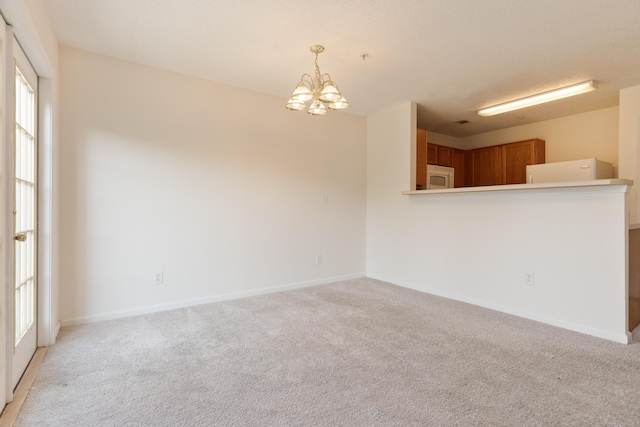 282 Swaying Pine Ct, Crestview, FL 32539 - empty room with light colored carpet, a chandelier, and baseboards