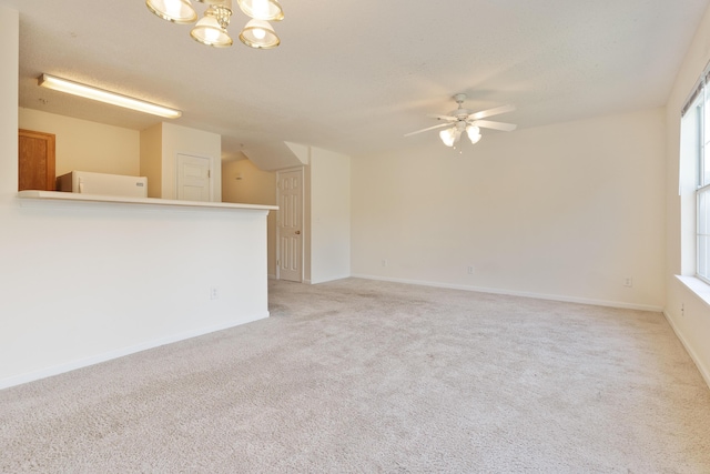 282 Swaying Pine Ct, Crestview, FL 32539 - unfurnished living room featuring light colored carpet, ceiling fan, a chandelier, and baseboards