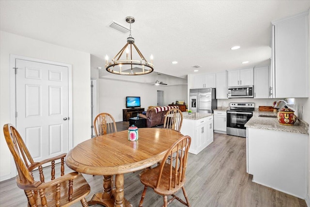 3163 Haskell Langley Rd, Crestview, FL 32539 - dining area with a chandelier, light wood finished floors, ceiling fan, and recessed lighting