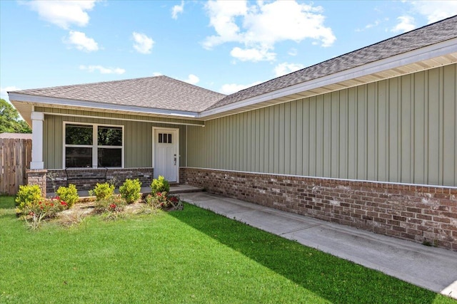 3163 Haskell Langley Rd, Crestview, FL 32539 - doorway to property with brick siding, a shingled roof, covered porch, and board and batten siding