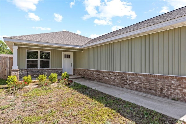 3163 Haskell Langley Rd, Crestview, FL 32539 - property entrance featuring brick siding, a shingled roof, fence, a porch, and board and batten siding