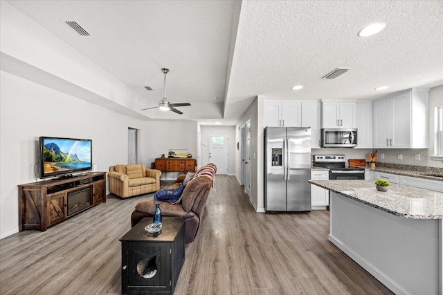3163 Haskell Langley Rd, Crestview, FL 32539 - living area with light wood-style flooring, baseboards, a ceiling fan, recessed lighting, and a textured ceiling