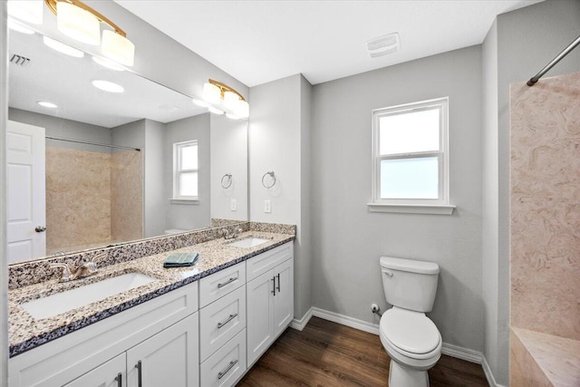 3163 Haskell Langley Rd, Crestview, FL 32539 - bathroom with wood finished floors, baseboards, toilet, a shower, and double vanity