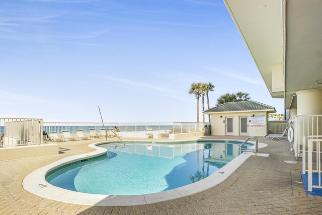 8601 Surf Dr Unit 2W, Panama City Beach, FL 32408 - community pool with fence, a patio, and a water view