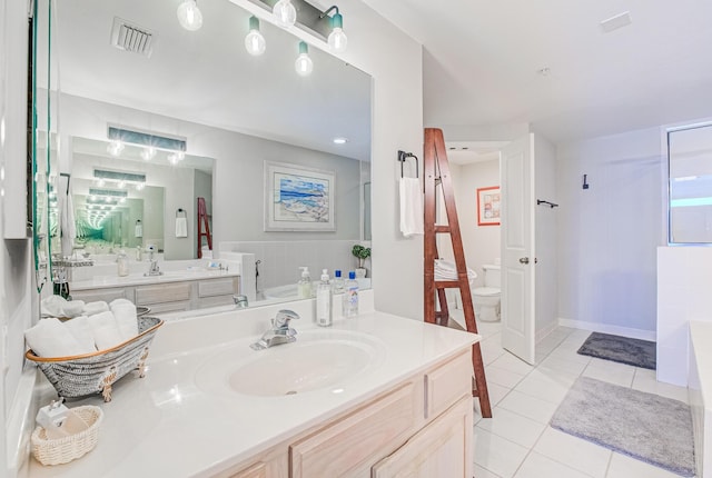 8601 Surf Dr Unit 2W, Panama City Beach, FL 32408 - bathroom featuring a garden tub, toilet, tile patterned flooring, and vanity