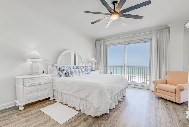 8601 Surf Dr Unit 2W, Panama City Beach, FL 32408 - bedroom with access to outside, ornamental molding, wood finished floors, a ceiling fan, and baseboards