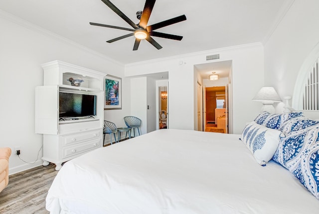 8601 Surf Dr Unit 2W, Panama City Beach, FL 32408 - bedroom featuring ornamental molding, wood finished floors, connected bathroom, ceiling fan, and baseboards