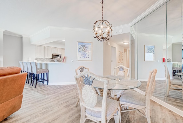 8601 Surf Dr Unit 2W, Panama City Beach, FL 32408 - dining area featuring ornamental molding, light wood finished floors, a chandelier, and baseboards