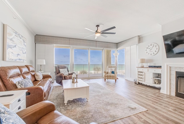 8601 Surf Dr Unit 2W, Panama City Beach, FL 32408 - living area with ornamental molding, ceiling fan, wood finished floors, and a tile fireplace