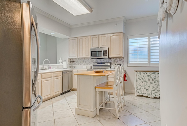 8601 Surf Dr Unit 2W, Panama City Beach, FL 32408 - kitchen with appliances with stainless steel finishes, ornamental molding, light tile patterned floors, backsplash, and light countertops