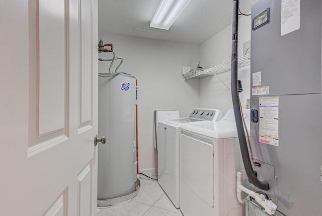 8601 Surf Dr Unit 2W, Panama City Beach, FL 32408 - laundry area with washer and dryer, heating unit, water heater, and light tile patterned flooring