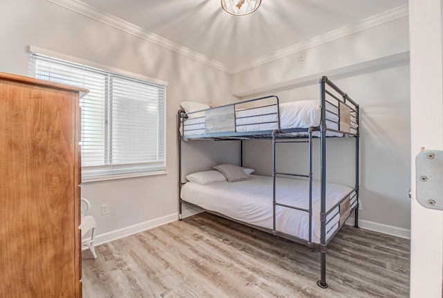 8601 Surf Dr Unit 2W, Panama City Beach, FL 32408 - bedroom featuring ornamental molding, wood finished floors, and baseboards