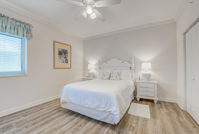 8601 Surf Dr Unit 2W, Panama City Beach, FL 32408 - bedroom featuring wood finished floors, crown molding, baseboards, a closet, and ceiling fan