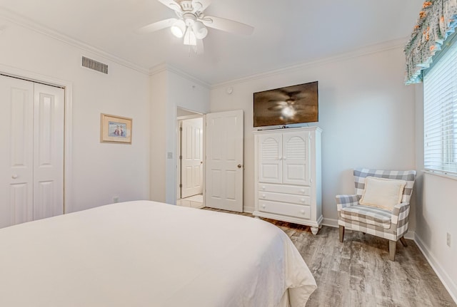 8601 Surf Dr Unit 2W, Panama City Beach, FL 32408 - bedroom with wood finished floors, ornamental molding, a closet, ceiling fan, and baseboards