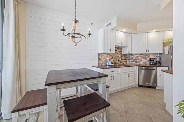 1096 Scenic Gulf Dr Unit 606, Miramar Beach, FL 32550 - kitchen with dishwasher, a sink, dark countertops, backsplash, and a chandelier