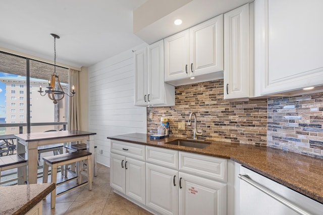1096 Scenic Gulf Dr Unit 606, Miramar Beach, FL 32550 - kitchen featuring a sink, decorative backsplash, dishwashing machine, a chandelier, and white cabinetry