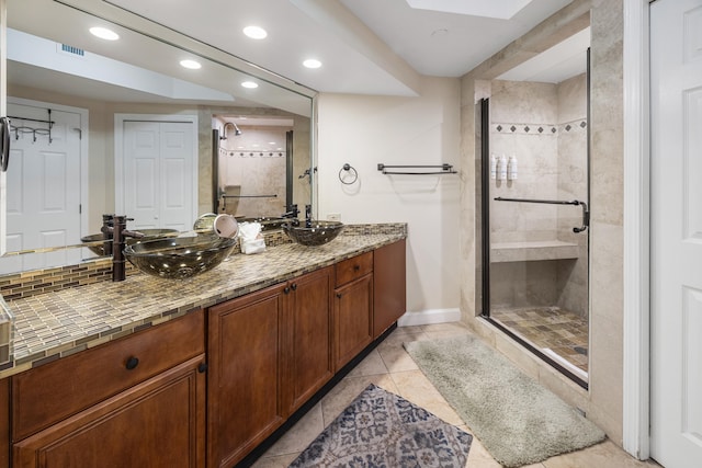 1096 Scenic Gulf Dr Unit 606, Miramar Beach, FL 32550 - full bathroom featuring a stall shower, recessed lighting, double vanity, tile patterned flooring, and baseboards