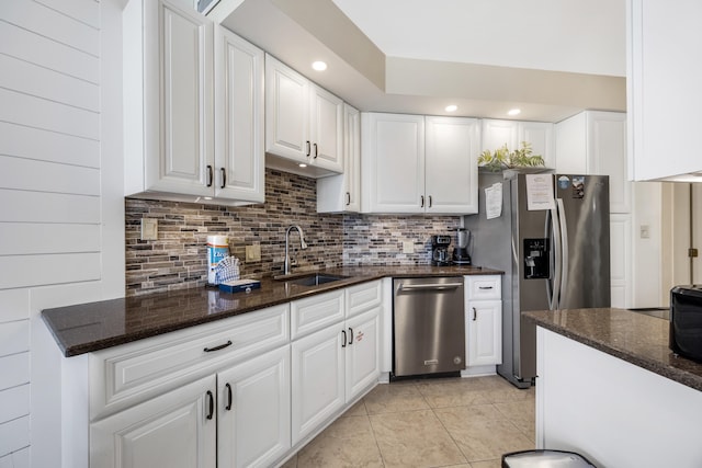 1096 Scenic Gulf Dr Unit 606, Miramar Beach, FL 32550 - kitchen featuring a sink, appliances with stainless steel finishes, tasteful backsplash, light tile patterned floors, and white cabinetry