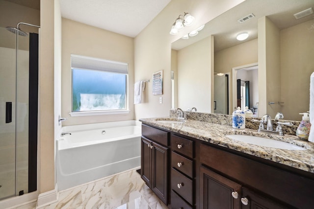bathroom with a stall shower, a bath, marble finish flooring, and double vanity