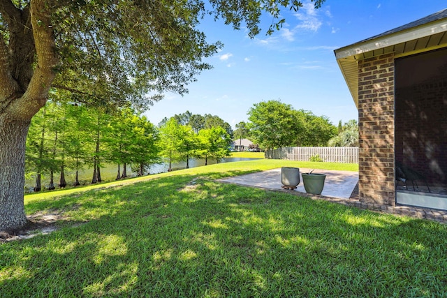 view of yard featuring a patio and a water view