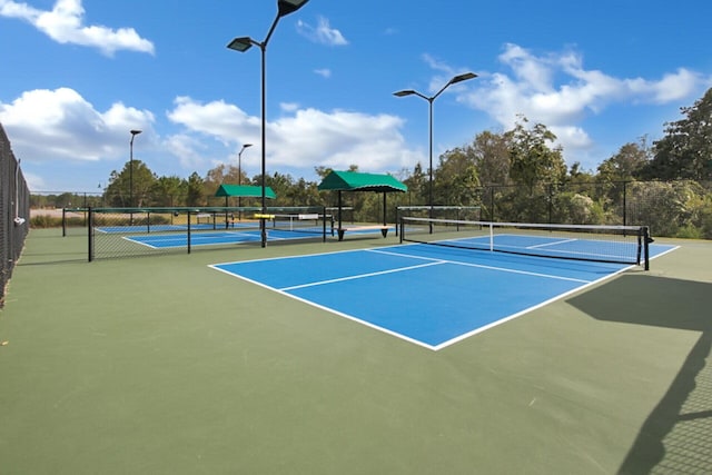 view of tennis court featuring fence