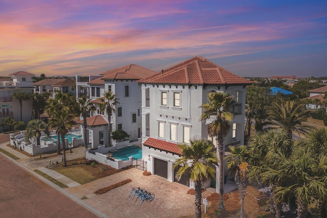 4782 Ocean Blvd, Destin, FL 32541 - view of front of house featuring a tiled roof, decorative driveway, an attached garage, and stucco siding